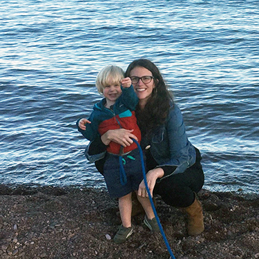 Anna Springer near water with a child